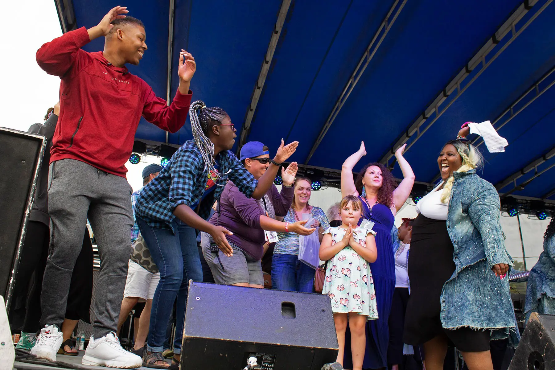 Large group dancing on the main stage at the Black Swamp Arts Festival